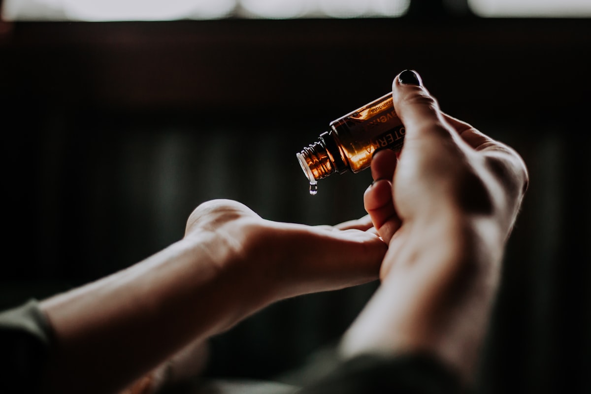 Massage oil poured into a therapist's hand